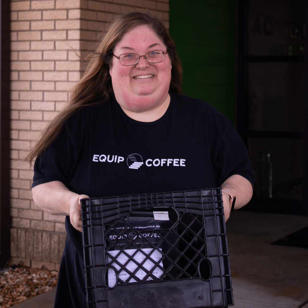 Woman holding crate of coffee
